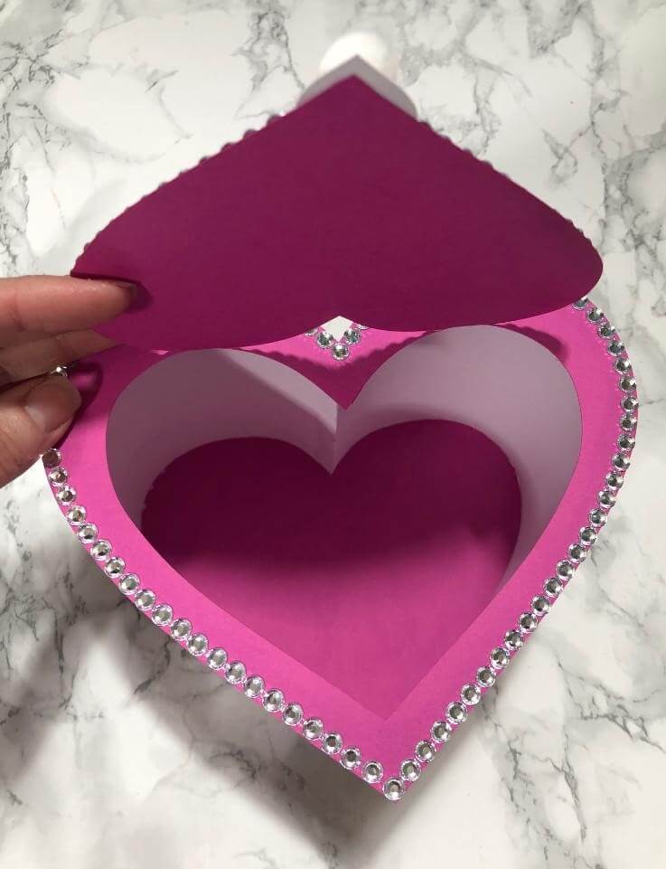 Lid of paper heart shaped box shown flipped open