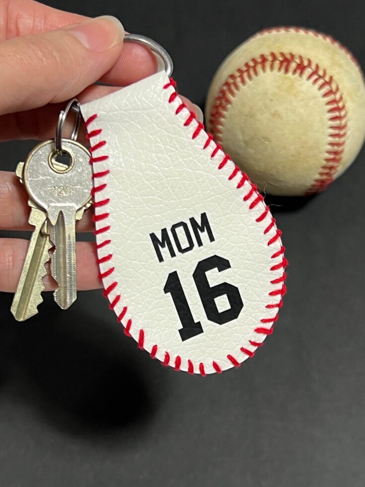 Handmade keychain that looks like part of a baseball.