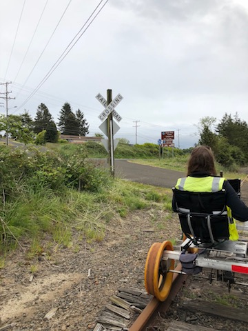 Oregon Coast Railriders cart at a railroad crossing sign
