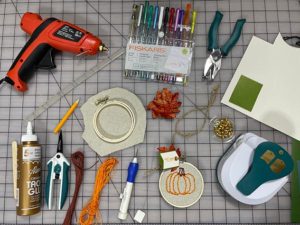 Supplies needed to make needle punch embroidered placeholders.