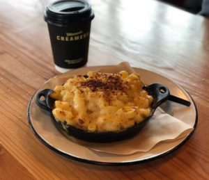 A skillet of macaroni and cheese from the Tillamook Creamery Cafe paired with a hot espresso drink.