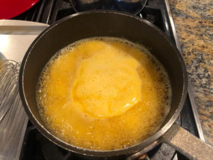 Boiling pot of pumpkin mixture for pumpkin spice churros