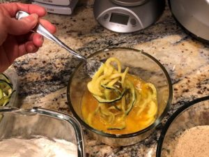 Floured zucchini coated in egg wash